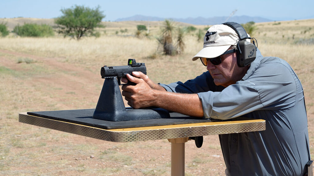 The author shooting the Walther WMP .22 WMR from the bench.