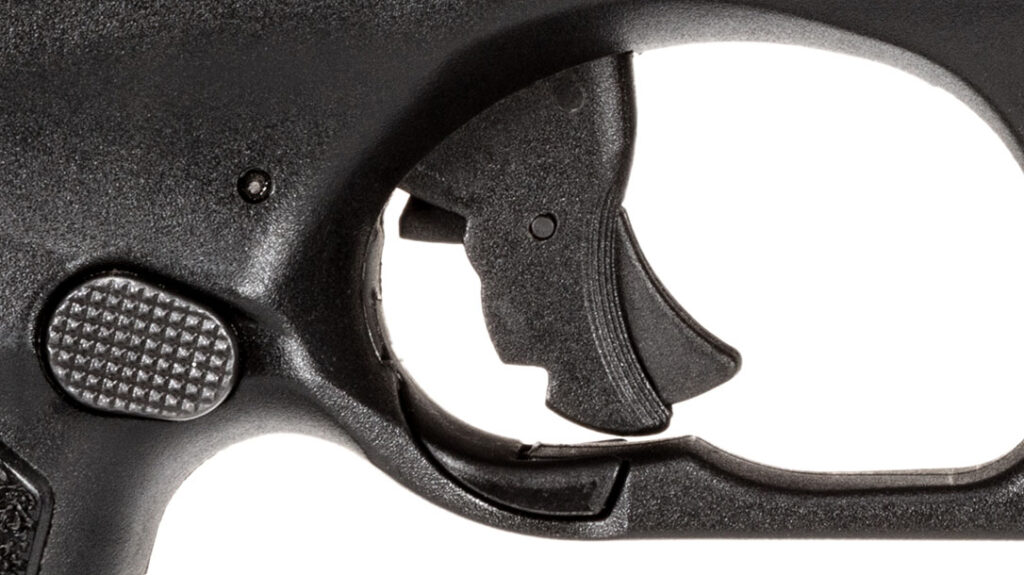 The trigger guard has a trigger block that can be flipped up to block the trigger from being accidentally depressed.