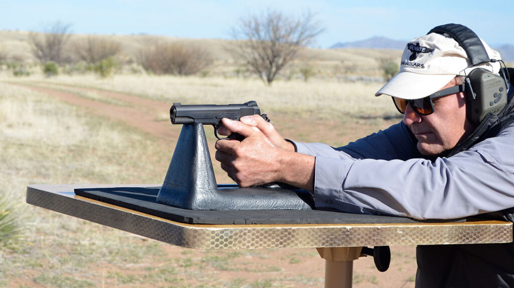 The author shooting the Colt 01911SE-A1 1911 Pistol from a bench rest.