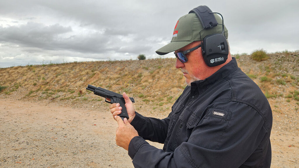 The author carries extra magazines with the Springfield Armory All-Black Emissary.