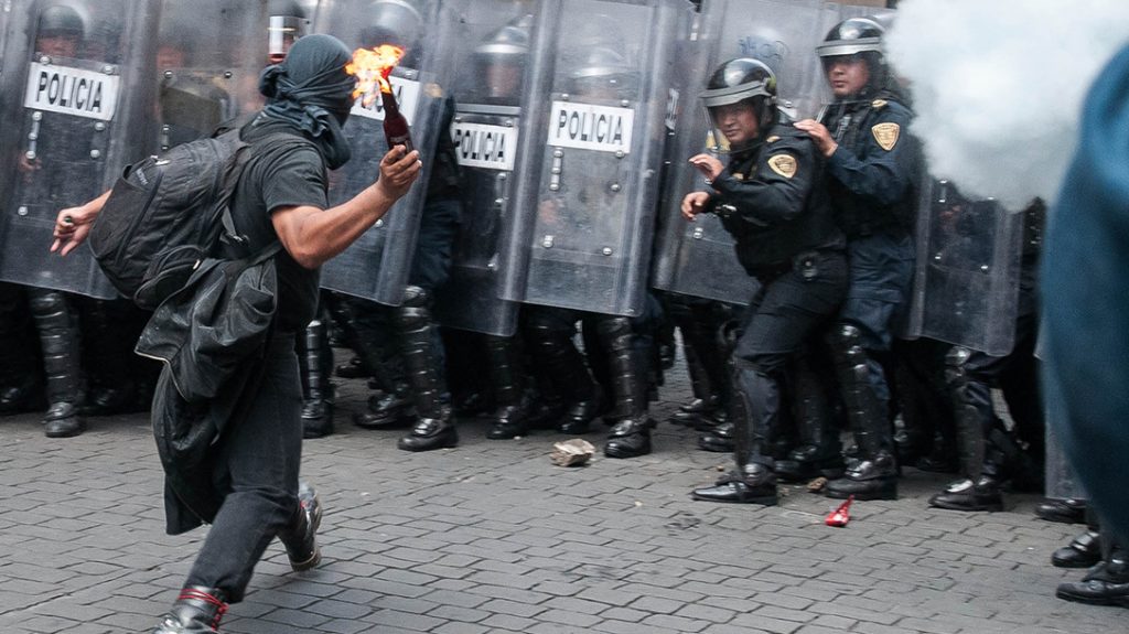 A leftist anarchist with a Molotov cocktail. Civil unrest is a growing problem worldwide.