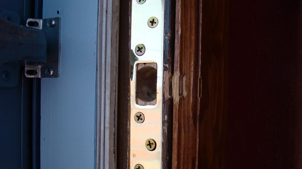 Good locks must be paired with solid hardware. This reinforced strike plate is larger and has more holes for mounting screws. Extra-long screws anchor it to the structural framework behind the door jamb.