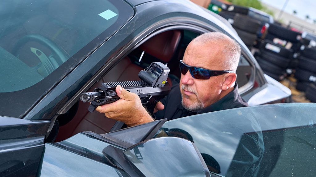 The author running the Phoenix 9mm Subgun from behind a car door.